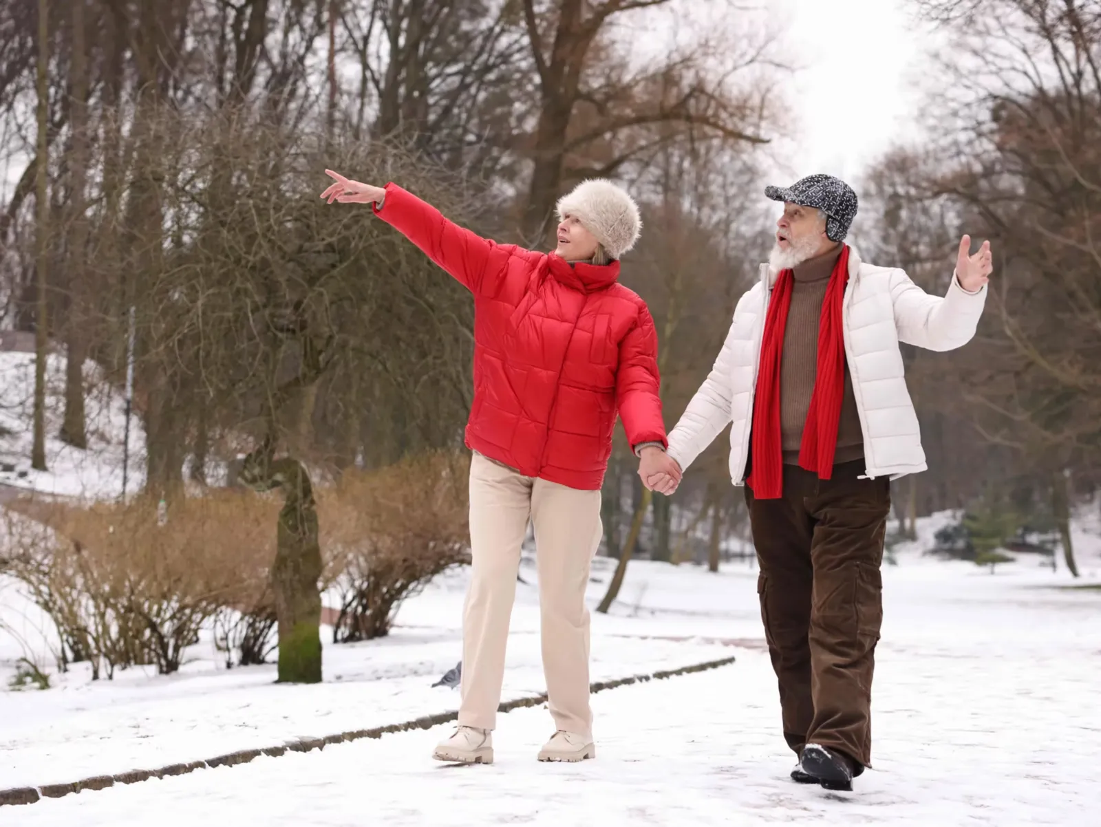 A couple holding hands on a snowy winter walk