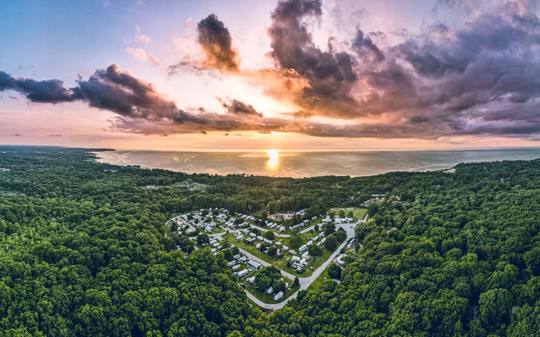 North Fork Resort from above at sunset, in the woods with the Long Island Sound beyond
