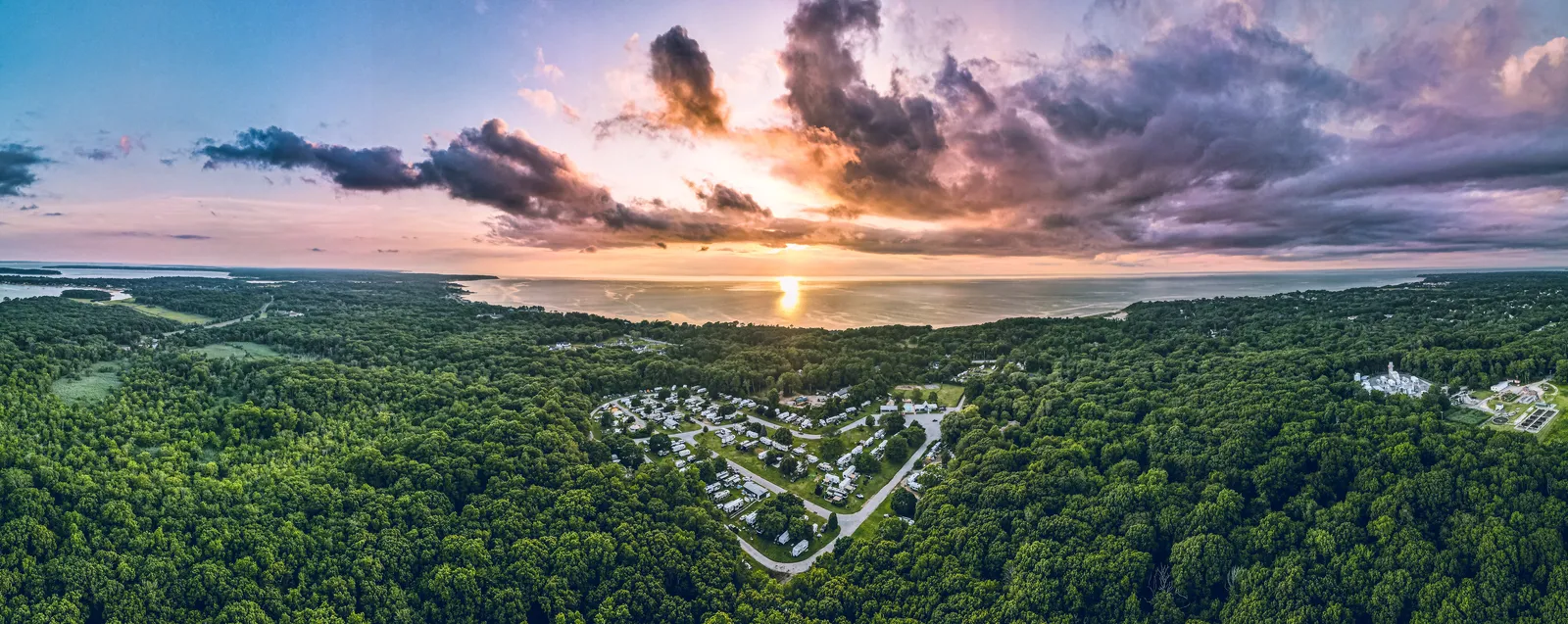 North Fork Resort from above at sunset, in the woods with the Long Island Sound beyond