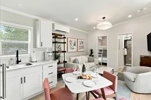 Cottage kitchen and dining table opening into the living room