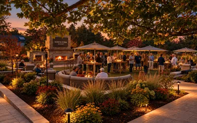 The Outdoor Living Room at North Fork Resort on a fall evening, with guests around the stone fireplace