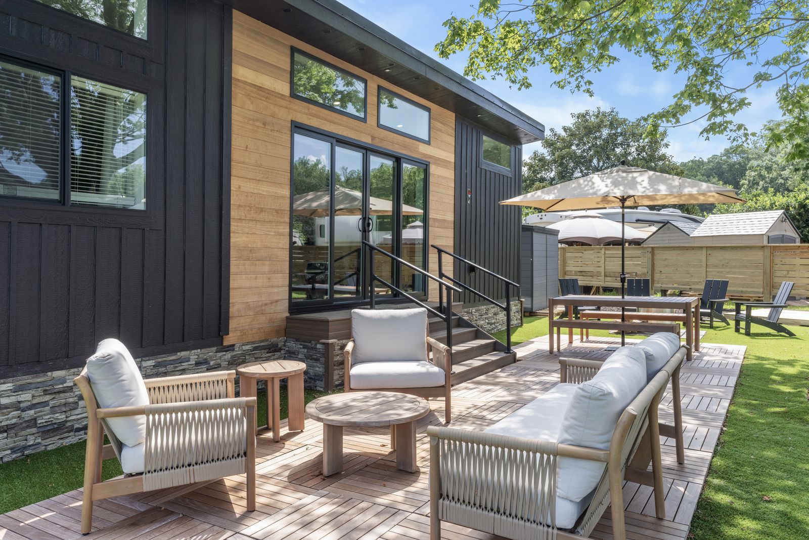 A North Fork Resort cottage with a wood deck, lounge seating and an umbrella table