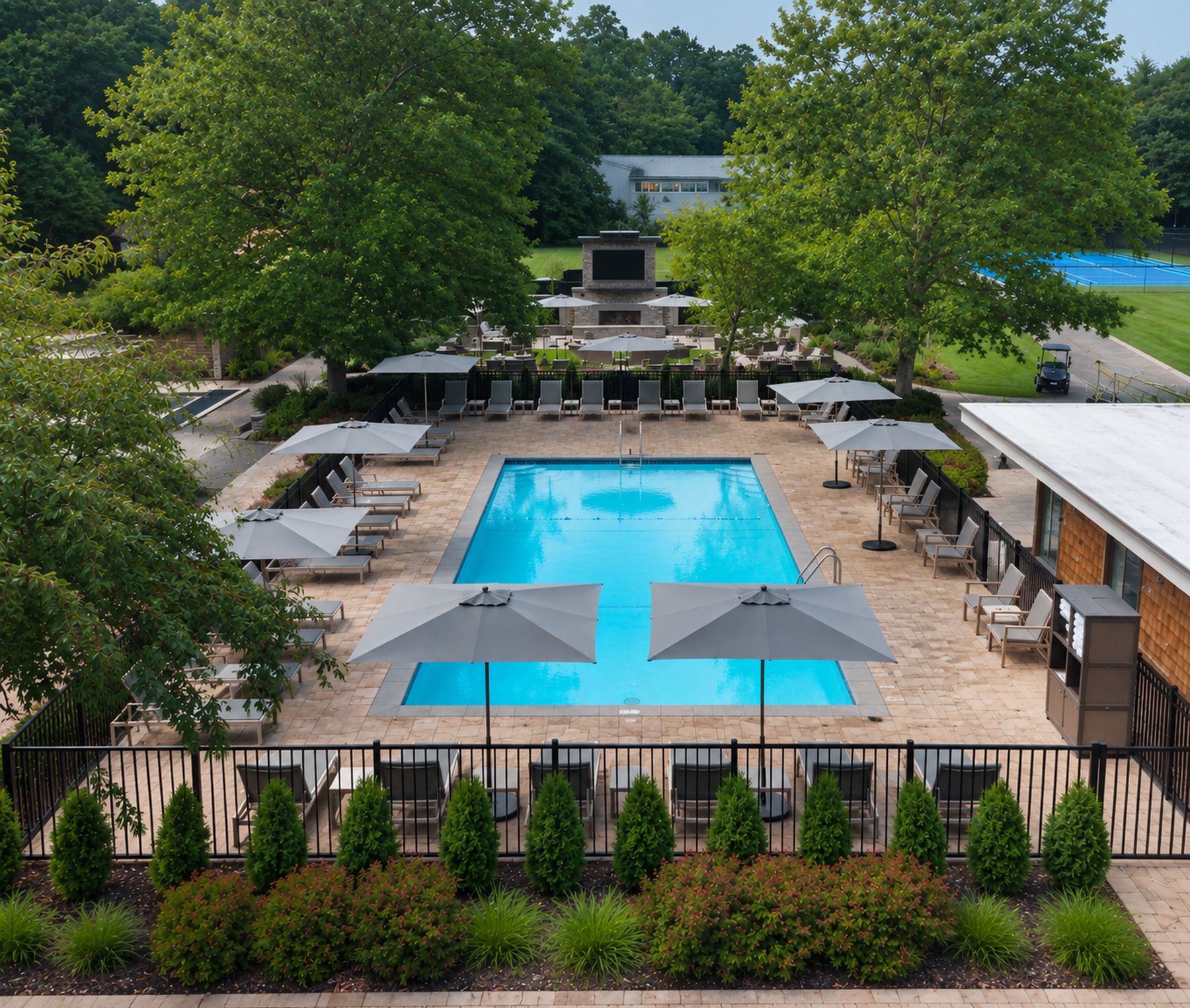 The pool at North Fork Resort with new gray lounge chairs and umbrellas, The Living Room beyond